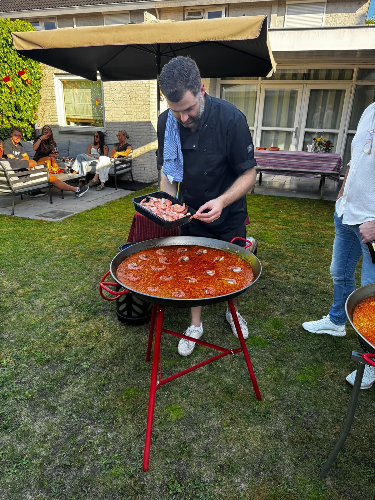 Axel kookt paella op een tuinfeest